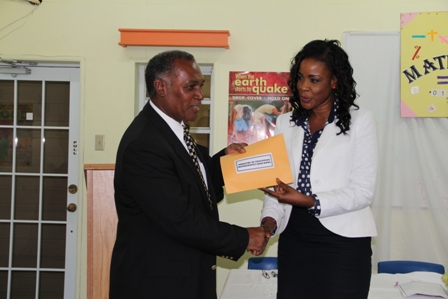 Premier of Nevis, Hon. Vance Amory receiving a check on behalf of the Department of Education from the Royal Bank of Canada (RBC) RBTT Representative Mrs. Corliss Sutton for sponsorship of the first Math Bowl Competition
